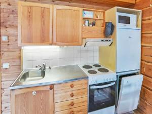 Holiday Home Porokaarre nr 14 by Interhome في روكا: مطبخ مع ثلاجة بيضاء ومغسلة