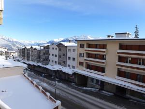 a view from the balcony of a building in the snow at Apartment Rond-Point by Interhome in Crans-Montana