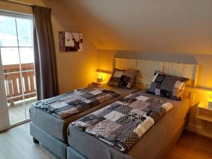 two beds in a room with a window at Apartment Top 13 by Interhome in Sankt Margarethen im Lungau