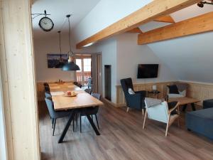 a dining room and living room with a table and chairs at Apartment Top 13 by Interhome in Sankt Margarethen im Lungau
