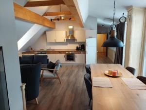a kitchen and living room with a table and chairs at Apartment Top 13 by Interhome in Sankt Margarethen im Lungau