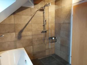 a shower stall in a bathroom with a tub at Apartment Top 13 by Interhome in Sankt Margarethen im Lungau
