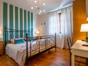 una camera da letto con letto a righe verdi e bianche di Holiday Home La Rondine by Interhome a Pugnano