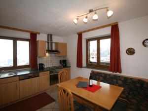 a kitchen with a wooden table and a dining room at Apartment Neurauter-1 by Interhome in Fügen
