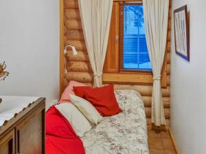 ein kleines Schlafzimmer mit einem Bett und einem Fenster in der Unterkunft Holiday Home Tahkon tikka by Interhome in Tahkovuori + 16 Fotos