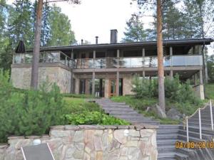 ein großes Haus mit einer Treppe davor in der Unterkunft Holiday Home Villa pinjaranta by Interhome in Tahkovuori