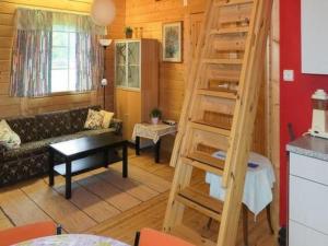 a living room with a spiral staircase in a room at Holiday Home Uisku by Interhome in Punkalaidun