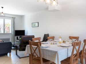 a dining room with a table and chairs at Holiday Home Les Lauriers by Interhome in Aigues-Mortes +20 photos