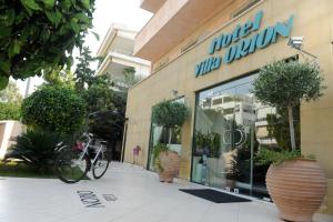 a bike parked in front of a store window at Villa Orion Hotel in Athens