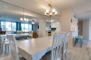 a dining room and kitchen with a table and chairs at Amazing Waterview Towers 104 Condo With Boat Slip in Destin