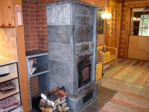 a fireplace in a room with a brick wall at Holiday Home Metsälä by Interhome in Kolinkylä