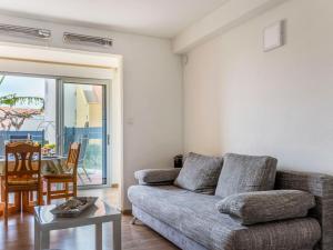 a living room with a couch and a table at Apartment Santa Monica 1 by Interhome in Cap d'Agde
