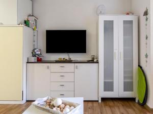 a living room with a tv on top of a dresser at Apartment Santa Monica 1 by Interhome in Cap d'Agde +26 photos