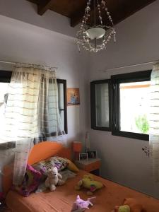 a bedroom with a bed with stuffed animals on it at Villa Evelina in Kalamata +12 photos