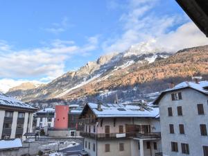 a view of a town with snow covered mountains at Studio San Anton by Interhome in Bormio