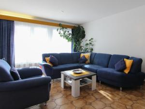 a living room with blue couches and a table at Apartment Casa Yolanda Mireille by Interhome in Fieschertal