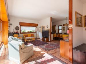 uma sala de estar com um sofá e uma televisão em Villa Villa Lucia by Interhome em Pellizzano