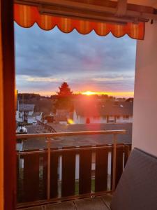 a view of the sunset from a balcony at Apartment Alpensicht by Interhome in Höchenschwand