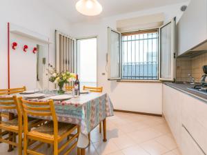 a kitchen and dining room with a table and chairs at Apartment Guglielmo e Anna by Interhome in Lignano Sabbiadoro