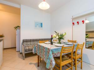 a dining room with a table and chairs at Apartment Guglielmo e Anna by Interhome in Lignano Sabbiadoro
