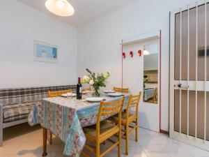 a dining room with a table and chairs at Apartment Guglielmo e Anna by Interhome in Lignano Sabbiadoro