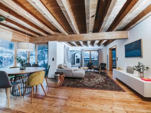 a dining room and living room with a table and chairs at Chalet Chalet 1018 by Interhome in Bad Gastein