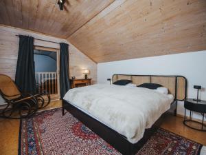 a bedroom with a large bed and a wooden ceiling at Chalet Chalet 1018 by Interhome in Bad Gastein