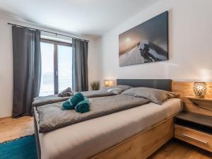 a bedroom with a large bed with a mountain at Apartment Bergleben by Interhome in Taxenbach