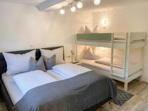 a bedroom with two bunk beds and a mirror at Apartment Ferienwohnung Apart Martina by Interhome in Wiesing