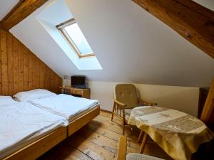 1 dormitorio con 1 cama, 1 silla y 1 ventana en Holiday Home Zlatá Olešnice 122 by Interhome, en Zlatá Olešnice
