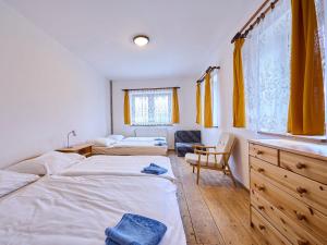 a bedroom with two twin beds and a sink at Holiday Home Zlatá Olešnice 122 by Interhome in Zlatá Olešnice