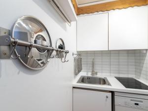 a kitchen with a sink and a mirror on the wall at Studio Palafour - Le Lac-6 by Interhome in Tignes