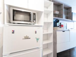 a kitchen with a microwave on top of a refrigerator at Studio Palafour - Le Lac-6 by Interhome in Tignes