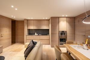 a kitchen and dining room with a table and chairs at Campiglio WOOD in Madonna di Campiglio