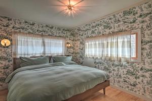 a bedroom with a large bed with floral wallpaper at Cozy Woodstock Home with Fire Pit! in Woodstock