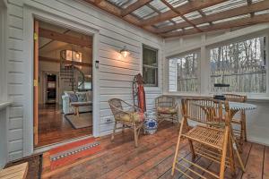 a porch with a table and chairs on a house at Cozy Woodstock Home with Fire Pit! in Woodstock