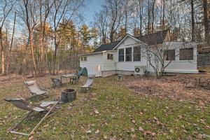 a house with chairs and a table in the yard at Cozy Woodstock Home with Fire Pit! in Woodstock