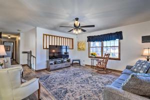 a living room with a couch and a tv at Cozy Vacation Rental Home Near Watauga Lake! in Elizabethton