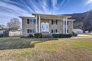 a brick house with a white door in a yard at Cozy Vacation Rental Home Near Watauga Lake! in Elizabethton