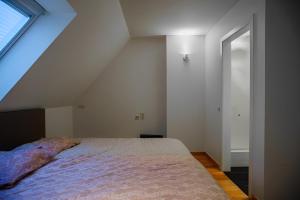 a bedroom with a large bed in a attic at Big and comfortable triplex in Knokke in Knokke-Heist