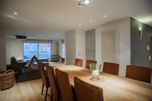 a dining room and living room with a table and chairs at Big and comfortable triplex in Knokke in Knokke-Heist