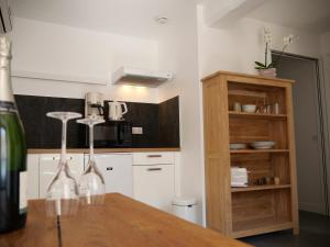 a kitchen with a wooden table and a microwave at Le Relais de l'endormie in Nogent-sur-Seine