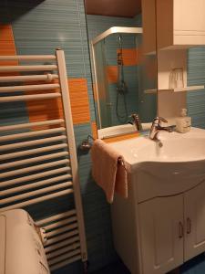 a bathroom with a sink and a mirror at Apartma Kramar Podkoren in Kranjska Gora