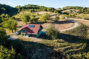an overhead view of a house with a solar roof at Rose Hip Hill Guesthouse in Valea Tîrnei