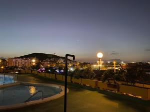 a view of a city at night with a street light at Simon beach house Los Cristianos in Los Cristianos +63 photos