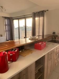 a kitchen with a counter with red appliances on it at 074DB on Dune Lark in Walvis Bay