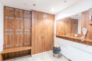 a locker room with wood paneling and a row of lockers at Penzion Blatnička in Blatnička