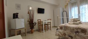 a room with a bed and a table and a kitchen at DA VINCI AFFITTACAMERE BORGO in Taranto