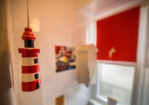 un faro giocattolo appeso a un muro in una stanza di Birds Nest Cottage Looe a Looe Altre 12 foto