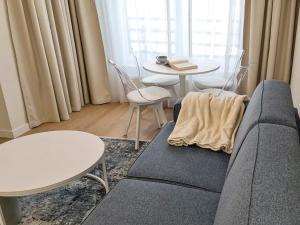 a living room with a couch and a table at Apartament Eveline in Kołobrzeg